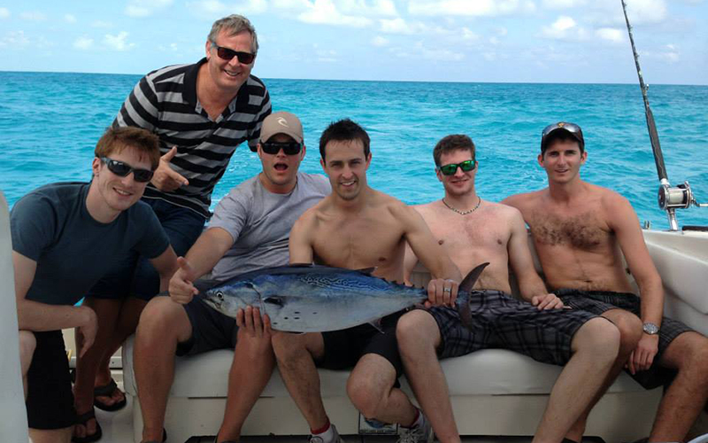 Men posing with large fish